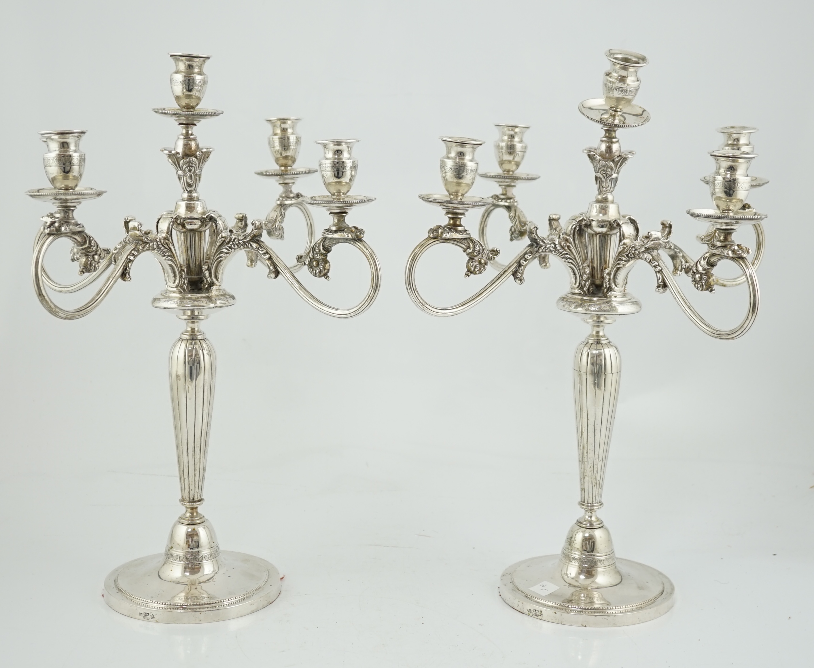 A pair of late 19th century Russian 84 zolotnik four branch, five light candelabra